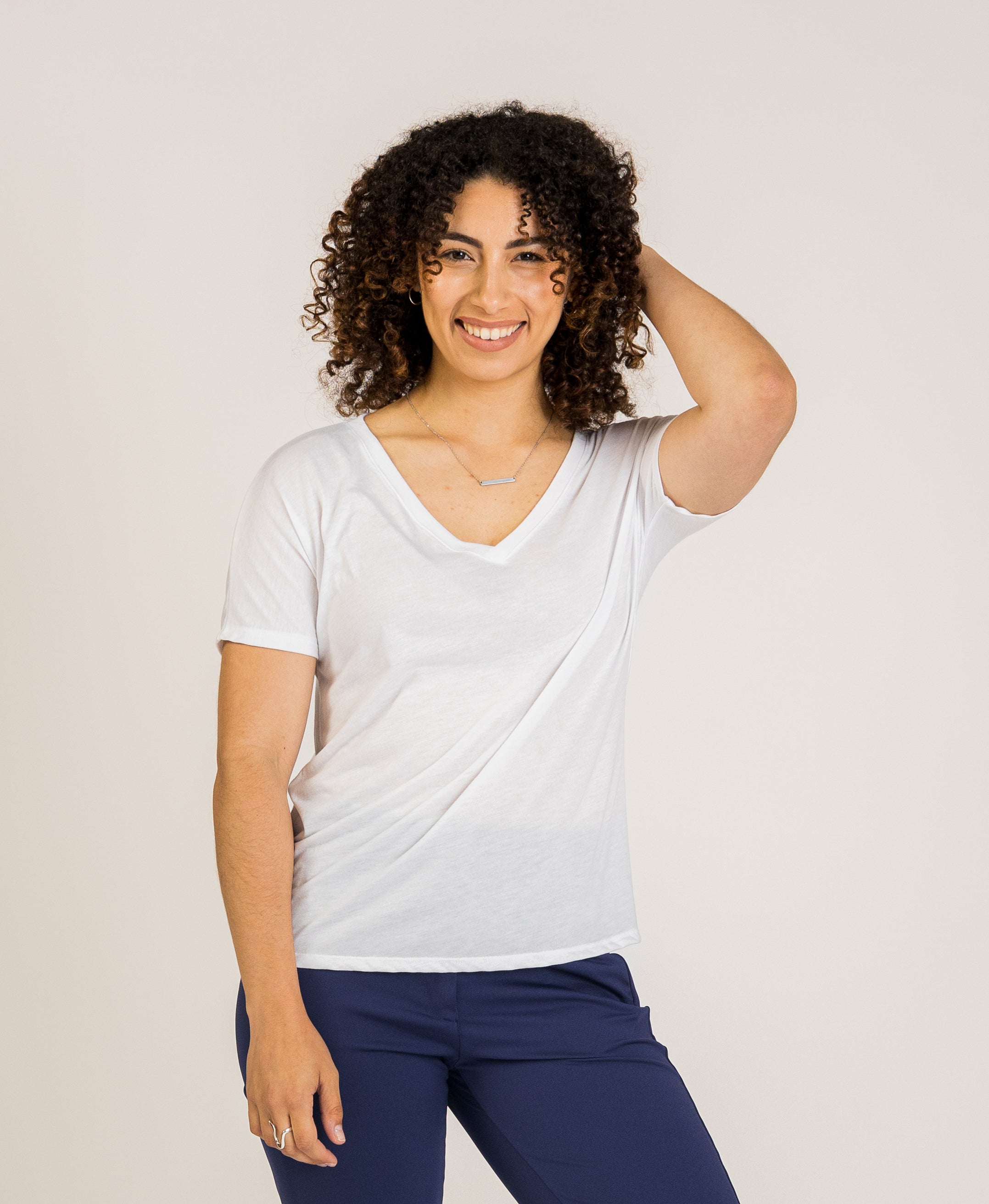 The Journey V-Neck by SISU, featuring a classic V-neckline and short sleeves, crafted to elevate work wear for women. An adaptable choice for professional outfits and business casual looks