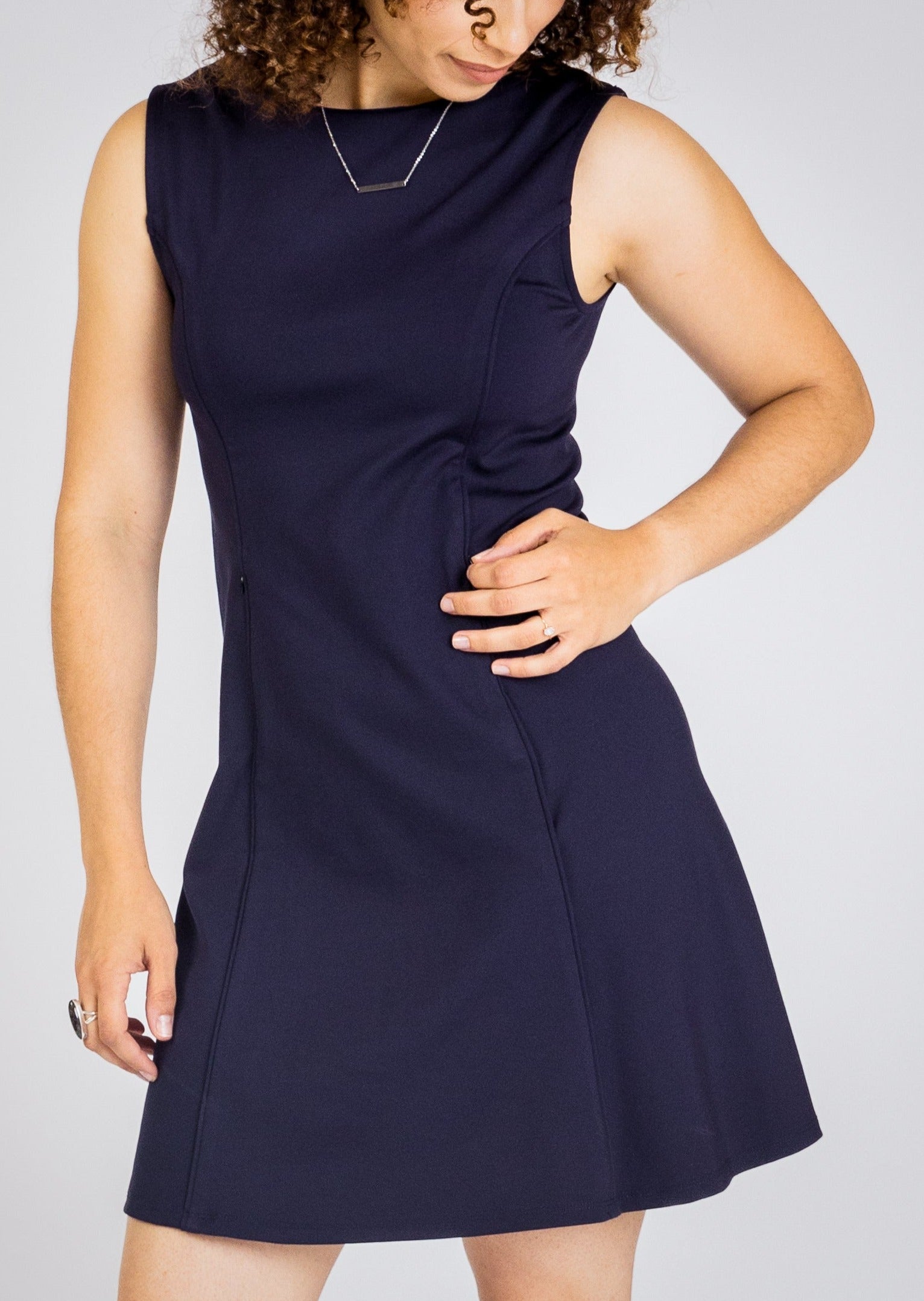 The Taylor Reversible Dress features a unique reversible design, allowing it to be worn in multiple ways. Functional side pockets add both style and practicality, making it perfect for professional environments.