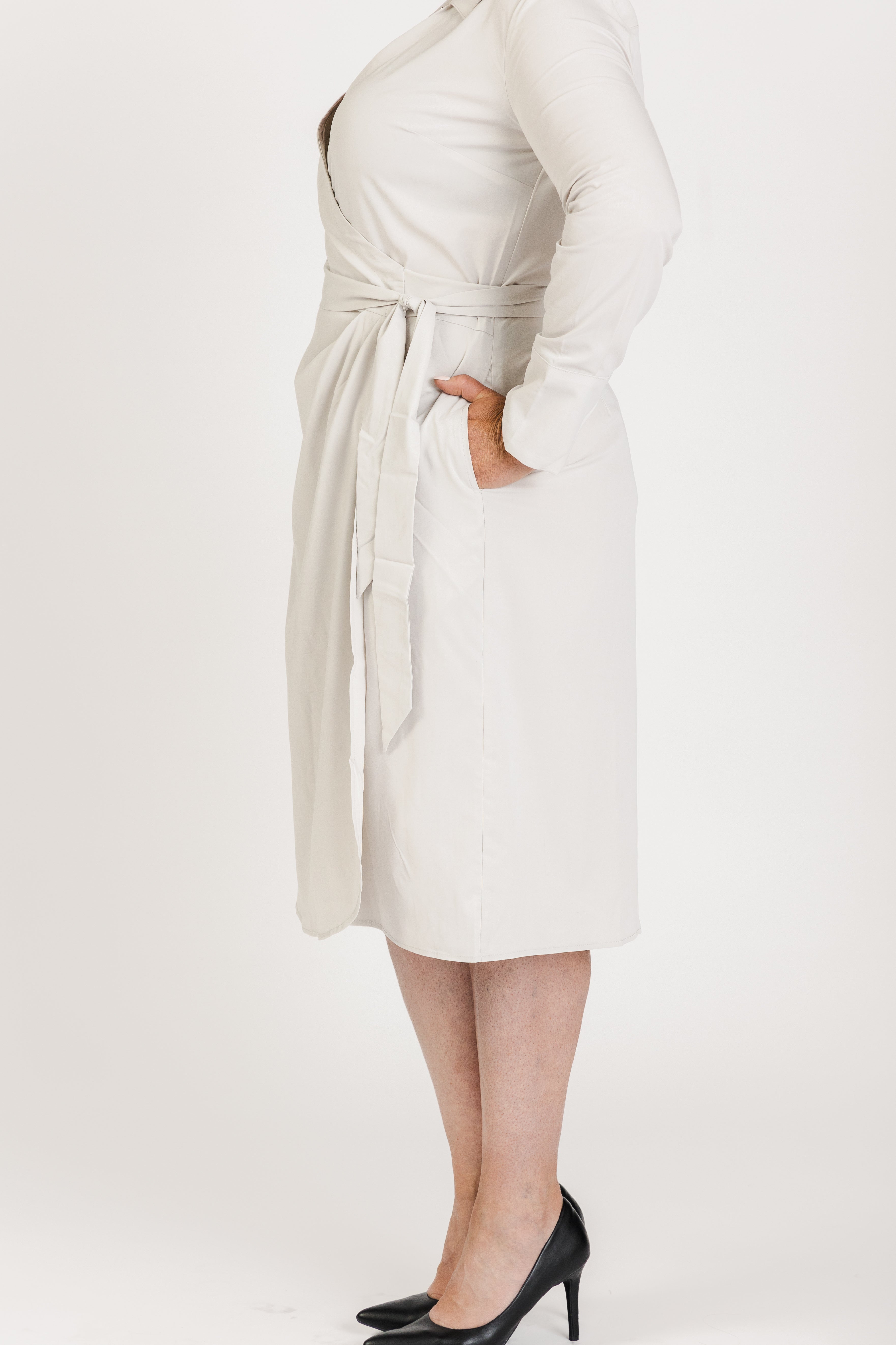 Look polished in the Trinity Wrap Dress, a versatile option for women’s corporate wear. With adaptable sleeves, flattering darting, and pockets for added convenience, this dress is tailored for business casual settings and everyday elegance."

