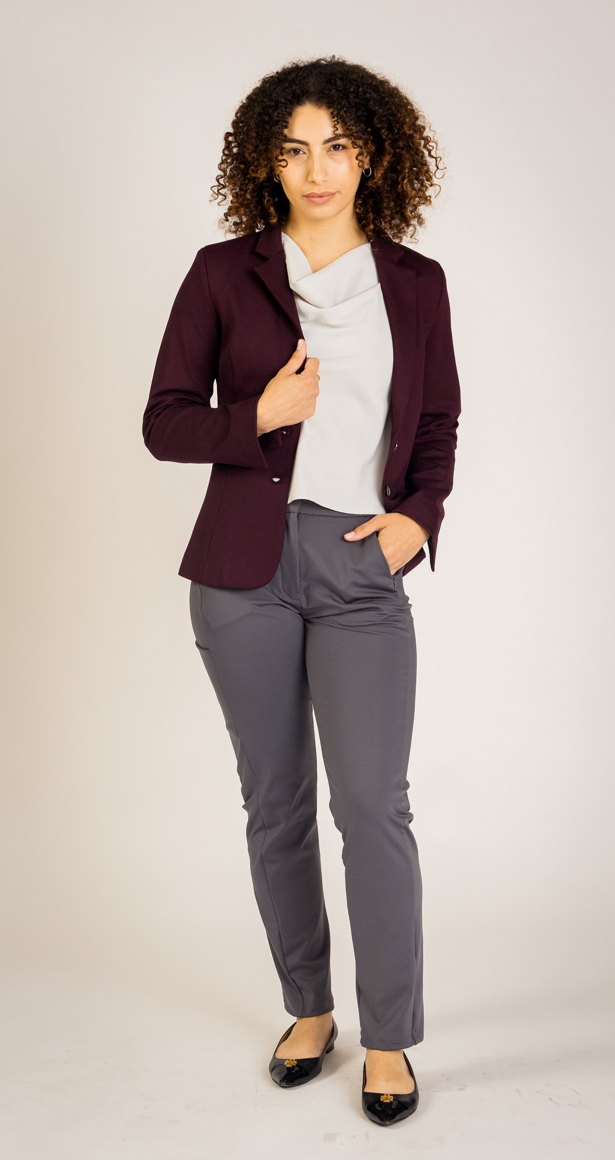 Sophisticated and functional, the Destiny Blazer features an adaptable performance fabric, unique cuff slits for easy sleeve adjustments, and three practical pockets. This blazer provides a seamless transition from work wear to evening events, ideal for business casual outfits